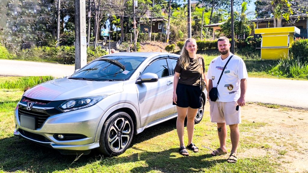 Car for Rent Lanta - Tourist smiling next to car rental in Koh Lanta, ready to explore island attractions